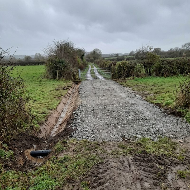 A freshly stoned farm track with a new drainage ditch cut alongside it